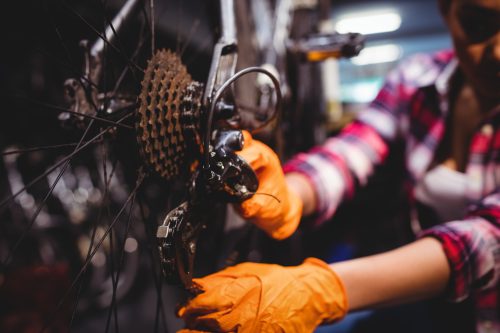 Mechanic repairing a bicycle in workshop